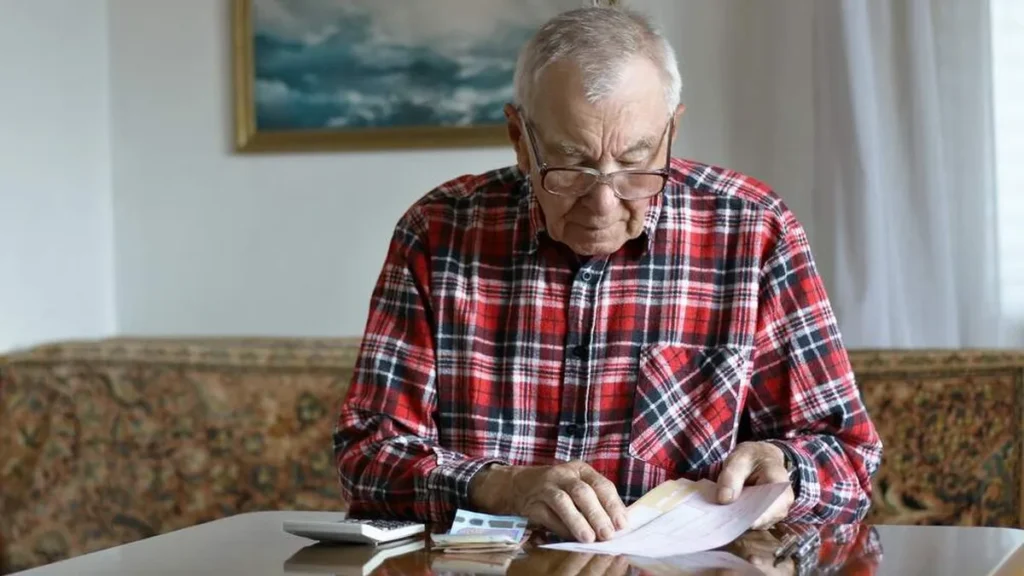 Imagem homem idoso vendo suas financas do artigo Dia do aposentado: como ter as finanças organizadas?