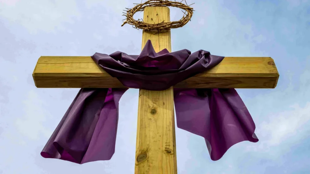 Imagem cruz de cristo com pano roxo e coroa de espinhos do artigo Por que Jesus passou por tentações?