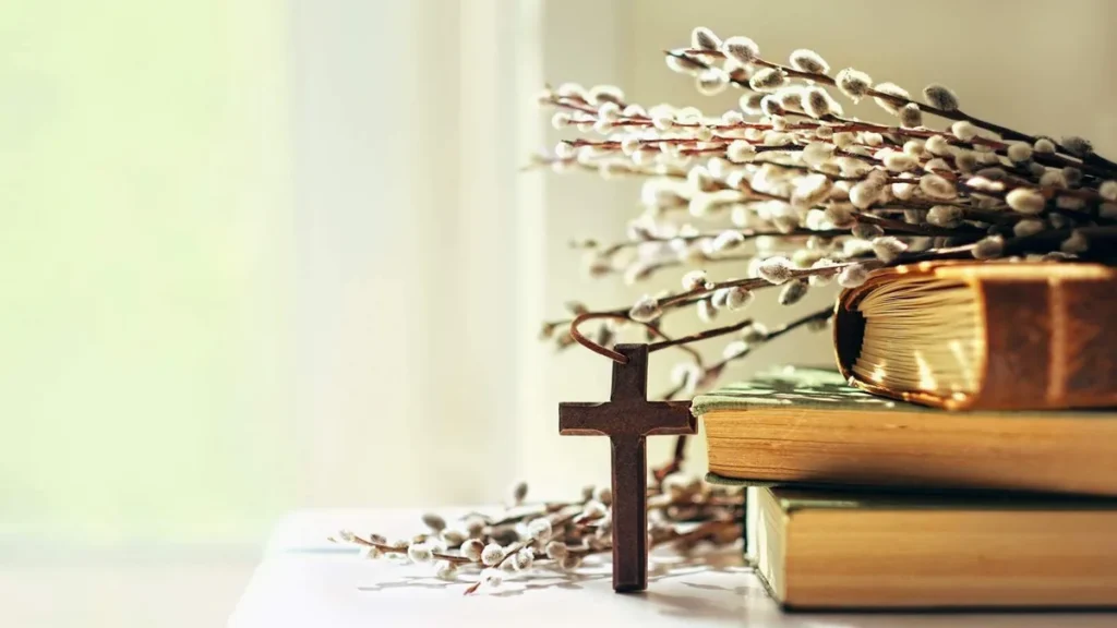 Imagem cruz apoiada em livros do artigo Para refletir: O tempo litúrgico não é monotonia