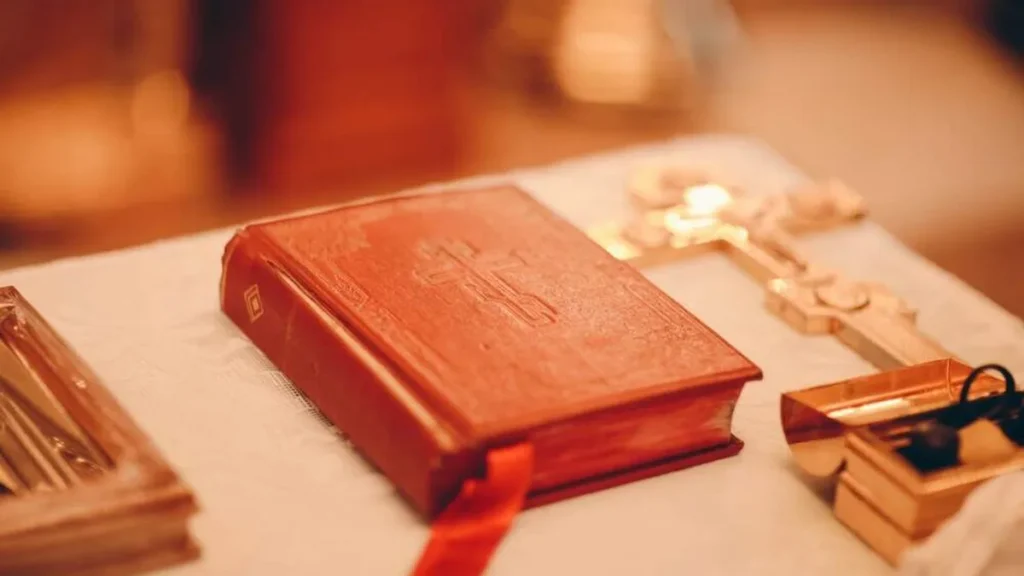 Imagem Lecionario e cruz sobre a mesa do artigo Você sabe o significado do Domingo da Palavra de Deus?