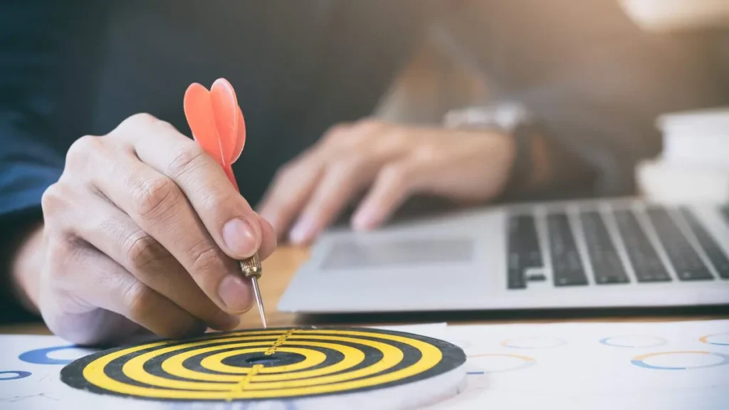 Imagem Homem com dardo na mao representando foco e estrategia profissional do artigo Mentalidade de crescimento: o caminho para o sucesso profissional
